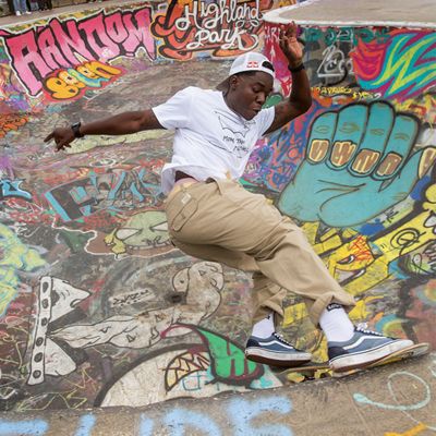Zion skating around a bowl covered in graffiti