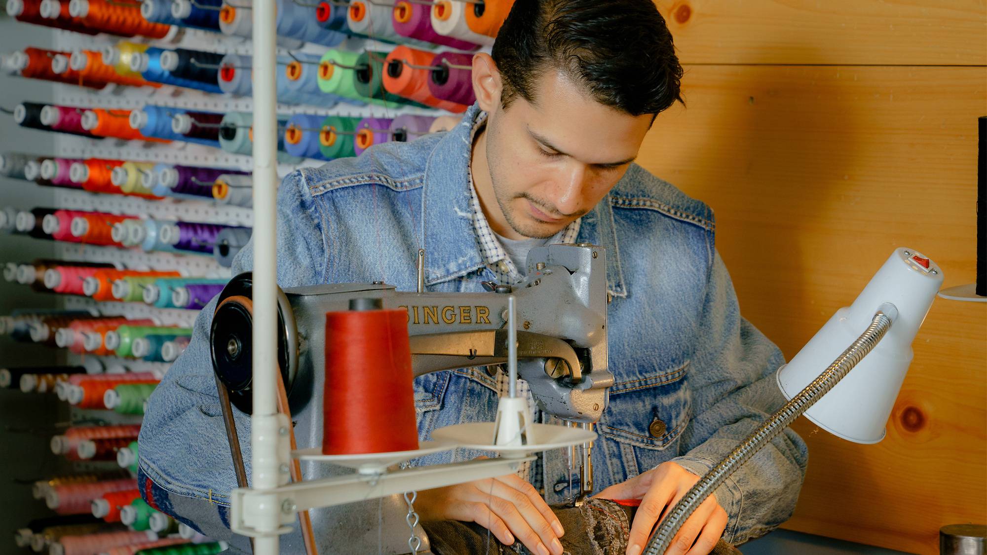 Photo of tailor Marco working in the Tailor Shop