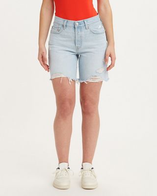 Model wearing black shorts with a white tank top.