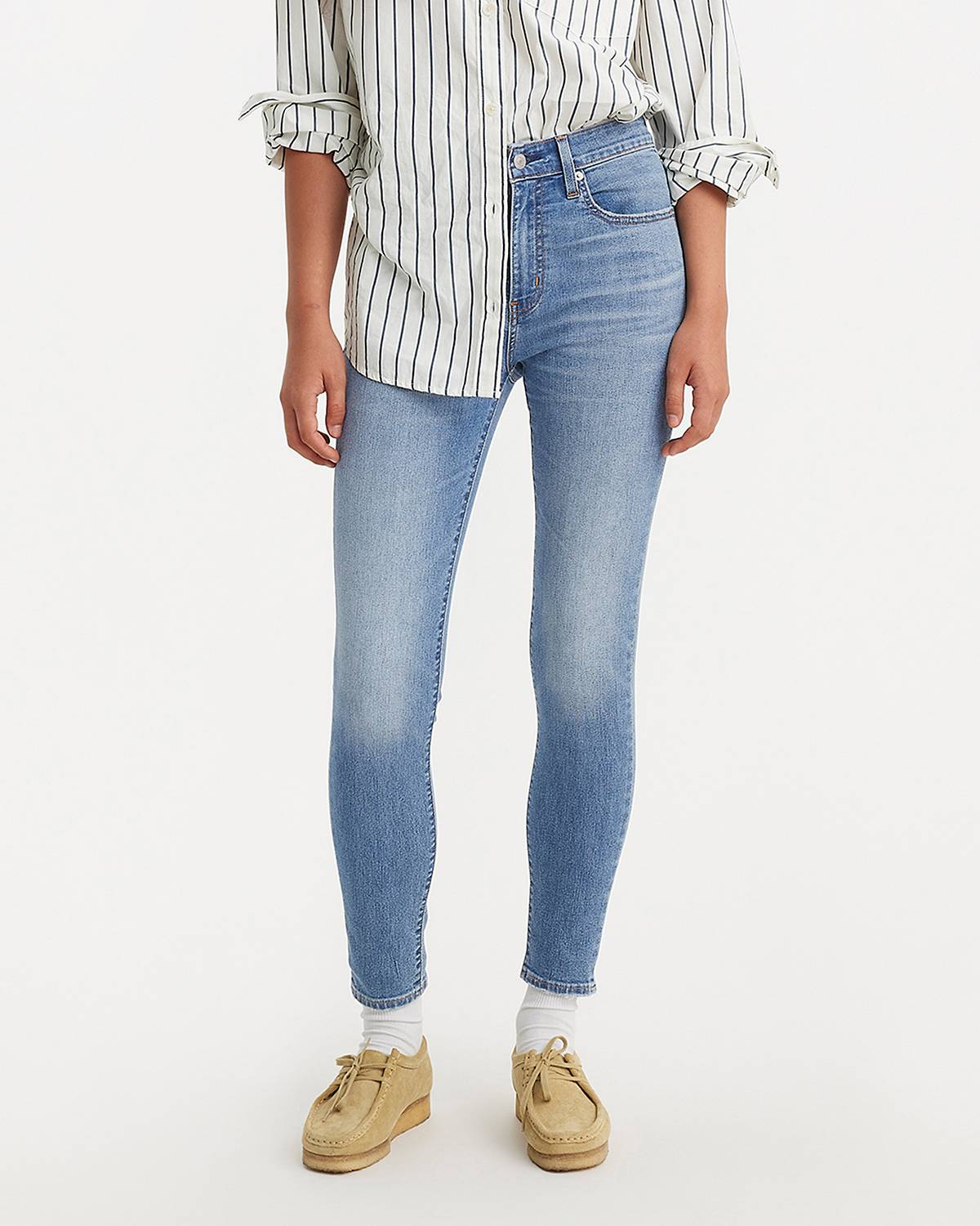 Female model wearing skinny fit jeans.