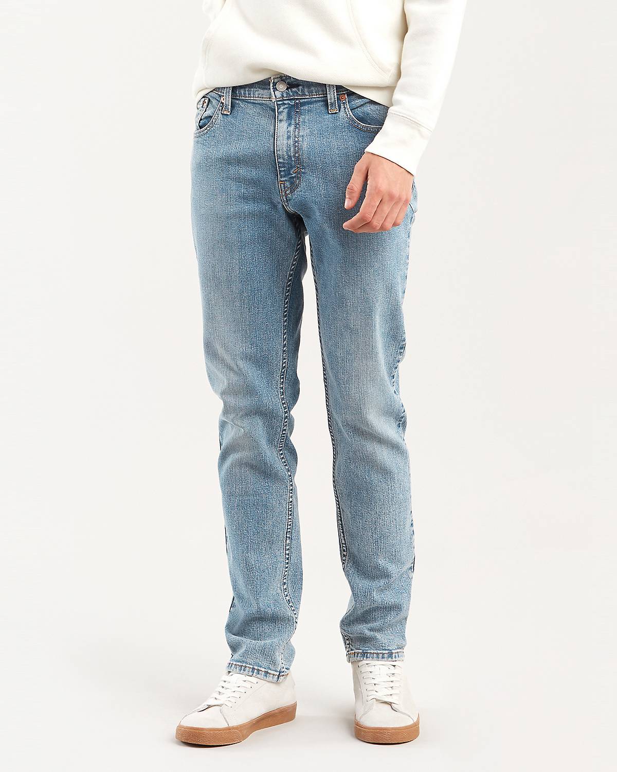 Male model wearing slim fit jeans.