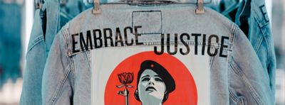 denim jacket with design saying embrace justice