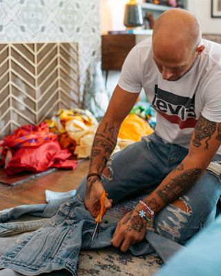 Johnny Wujek working on a denim jacket