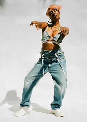 Portrait of a woman with pink hair wearing denim head-to-toe.