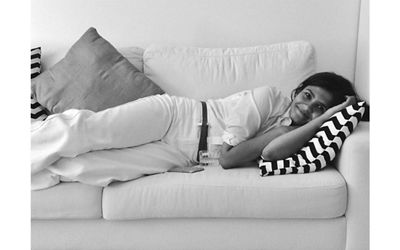 Black and white image of Tasnim Ahmed lying on a couch.