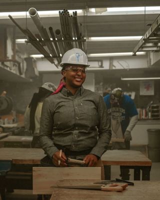 The longevity of levi's, woman working in industry wearing work hat and levi's clothing.