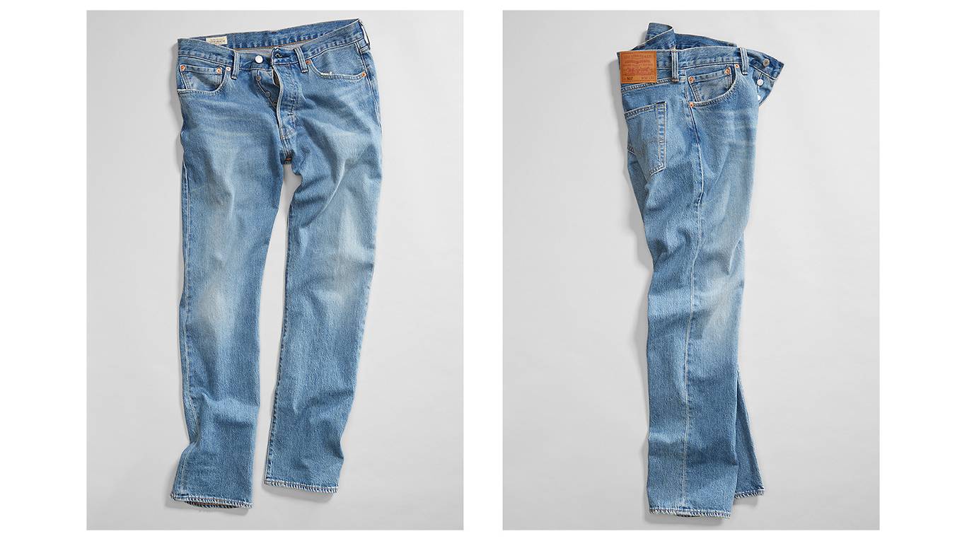 A pair of jeans spread out on the ground, two different angles of the jeans are shown.