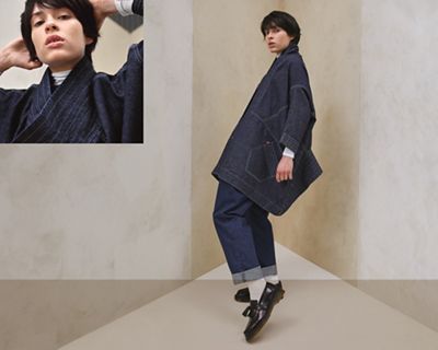 Two images of a model wearing the Upside-Downable Trucker Jacket. The image on the left is a close up shot of the model and the jacket's details around the neck. The image on the right is an image of the same model, standing on their toes.