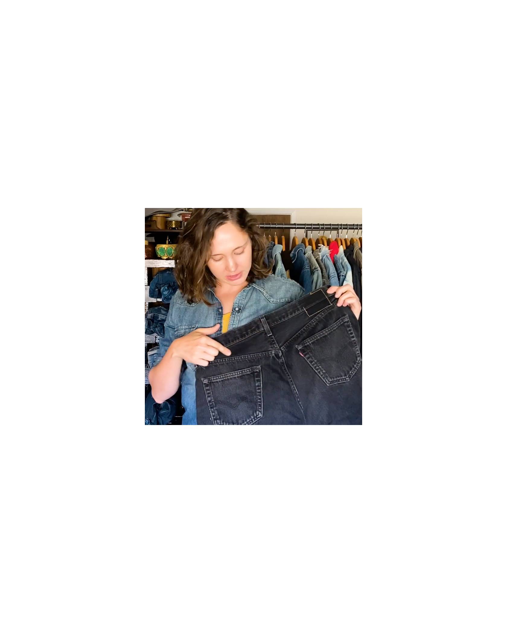 A women pointing to the yoke on a pair of jeans