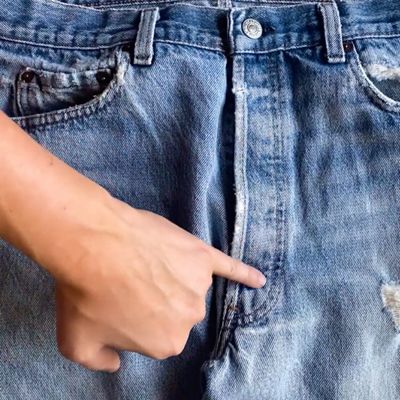 someone pointing the j-stitch on jeans