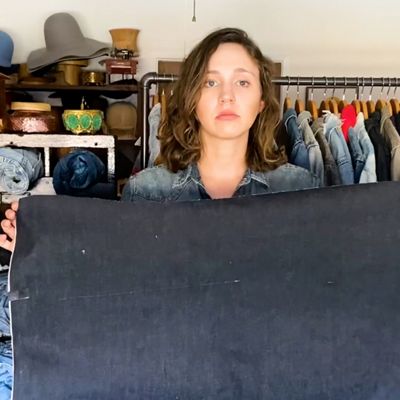 woman holding raw denim fabric