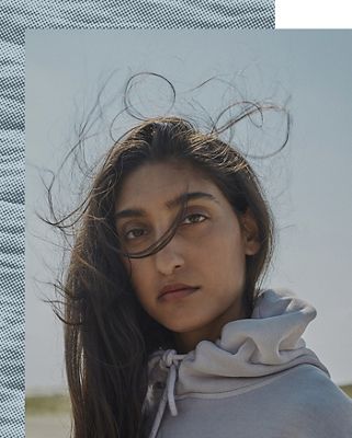 A portrait shot of a woman's face with her hair blowing in the wind