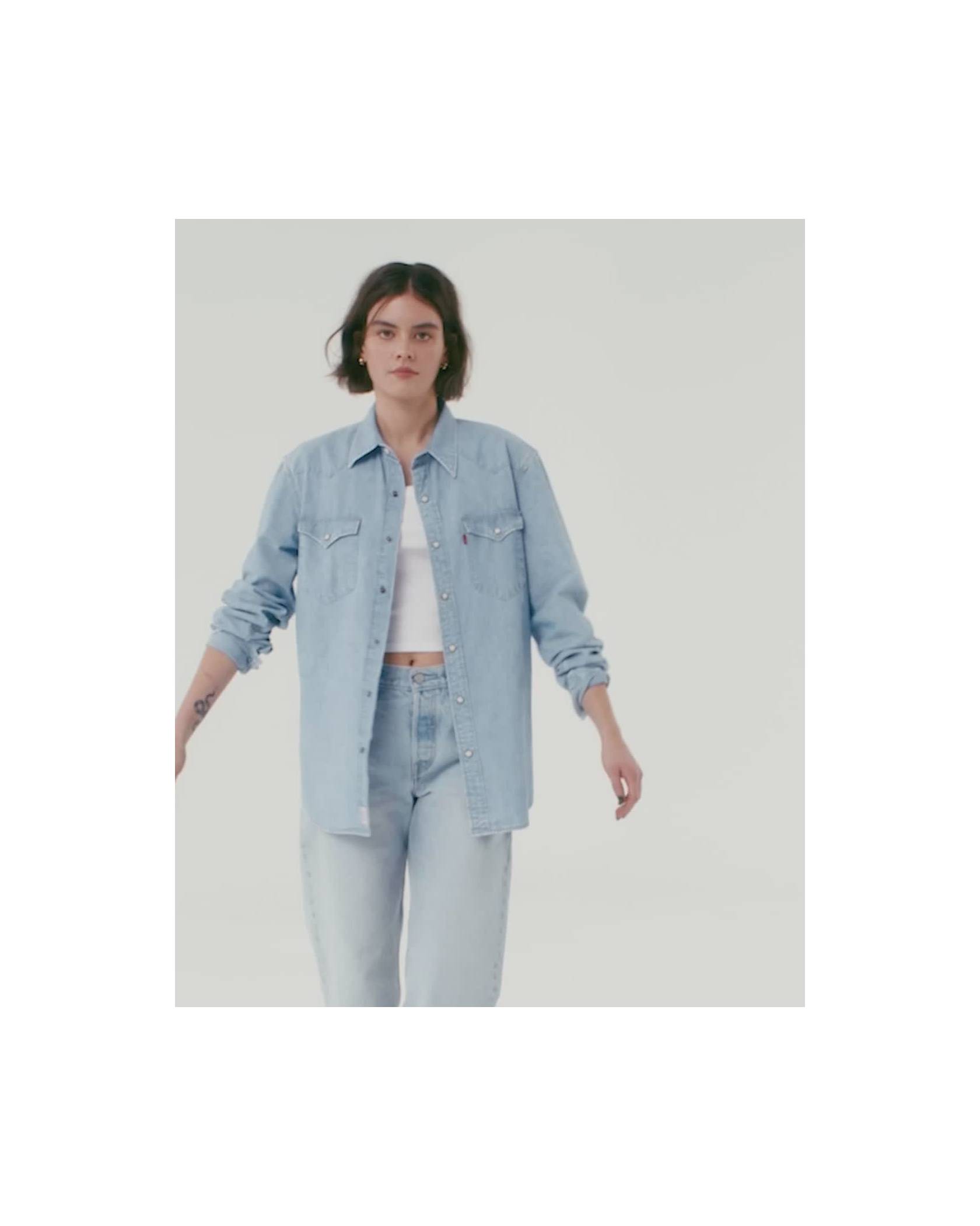 Video of model in women's light wash denim button down, light wash jeans and white tank