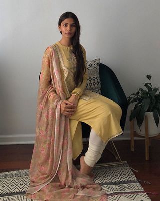 Image of Tasnim Ahmed sitting on a chair.