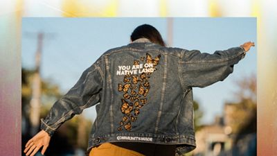 Xiuhtezcatl showing the back of a jean jacket that says "you are on native land"