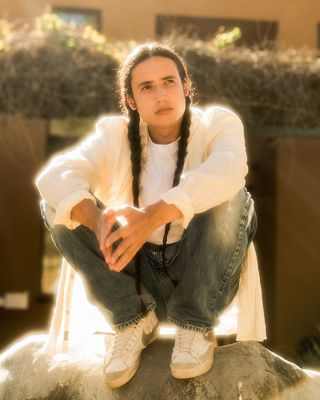 Three images with Xiuhtezcatl in the middle and an image of his community on each side.