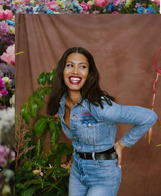 Leyna Bloom laughing wearing Levi's jeans and a denim button up Levi's shirt with her name embroidered on the front left pocket.
