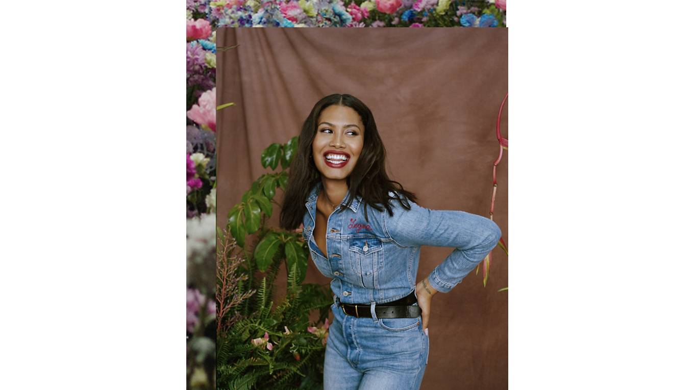 Leyna Bloom laughing wearing Levi's jeans and a denim button up Levi's shirt with her name embroidered on the front left pocket.