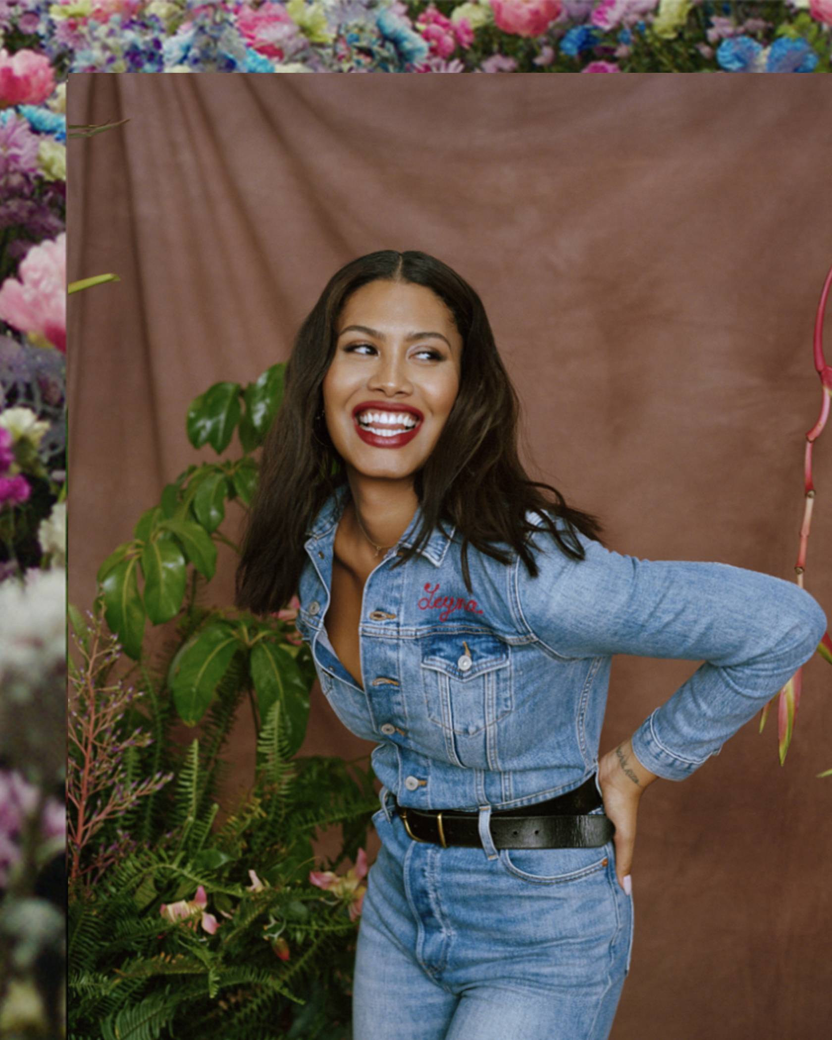 Leyna Bloom laughing wearing Levi's jeans and a denim button up Levi's shirt with her name embroidered on the front left pocket.