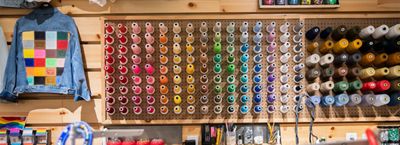 a wall of thread in the tailor shop