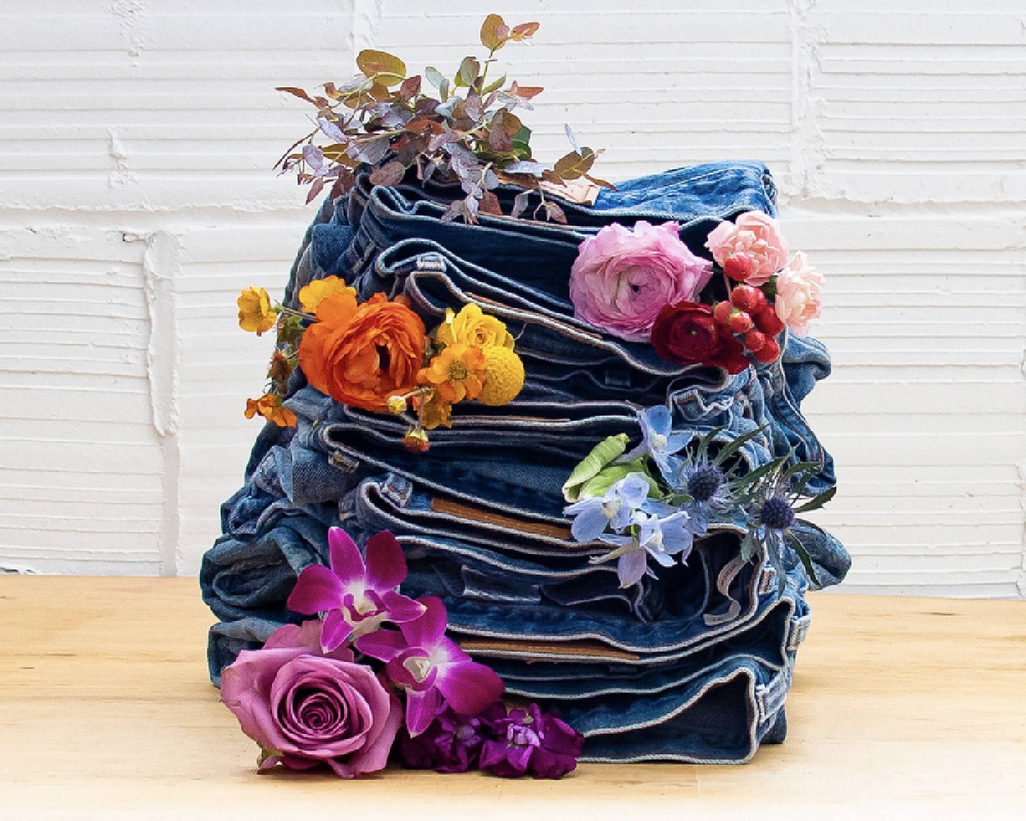 A stack of Levi jeans with flowers in between
