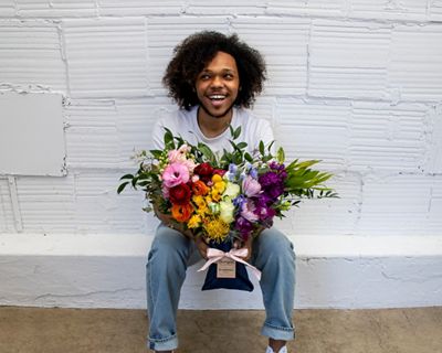 Someone sitting holding flowers