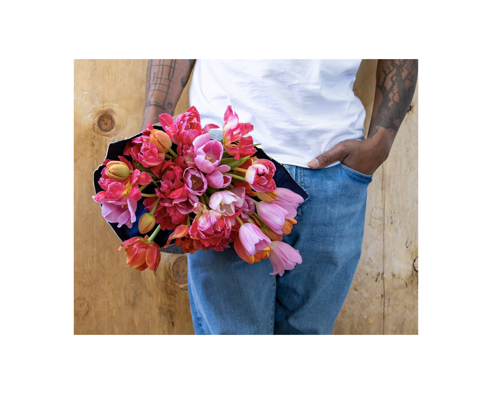 Someone holding a bouquet of pink roses