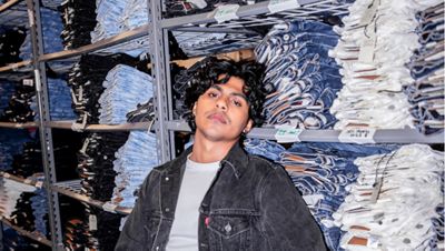 Levi's tailor Dillon Bramwell leaning against jeans