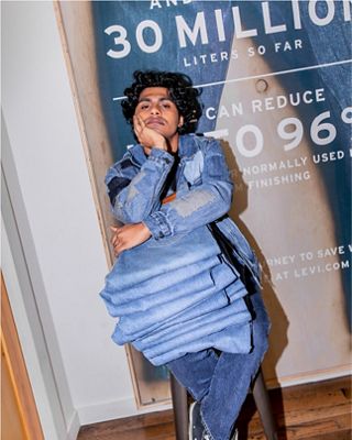 Dillon Bramwell siting with jeans on lap