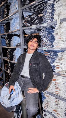 Levi's tailor Dillon Bramwell leaning against jeans