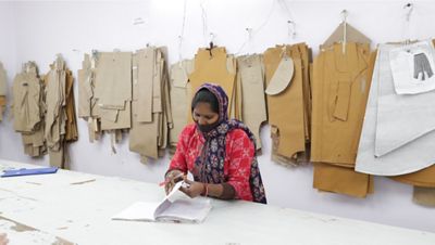 Women with fabric swatches behind her