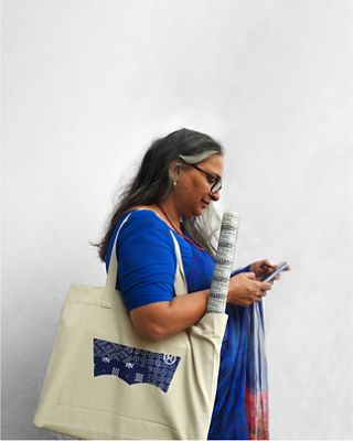 women holding fabric in tote bag
