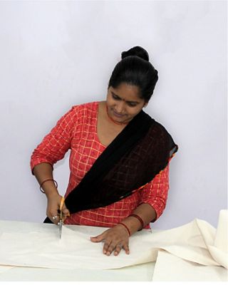 women cutting fabric