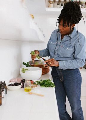 GIFs of Mennlay Golokeh Aggrey making a cannabis-infused salad in her kitchen. She is wearing a Levi's Western Shirt and jeans.