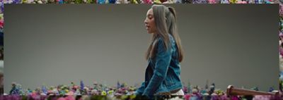 A photo of Haben Girma walking through flowers