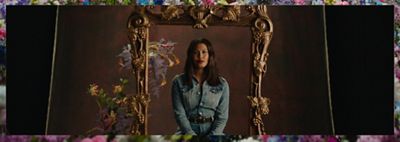 Leyna bloom sitting behind a golden frame