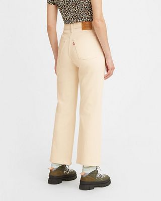 Model wearing white bootcut jeans