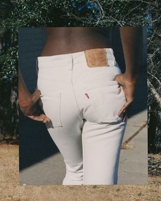 Butt shot of model wearing white Levi's jeans