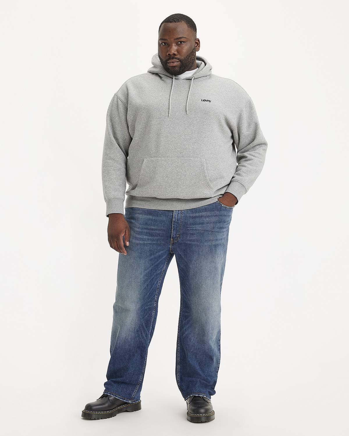 Model wearing jeans and a gray sweatshirt