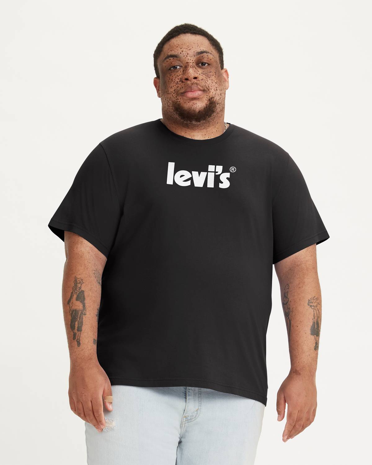 Model wearing black tee with white Levi's logo on the chest.