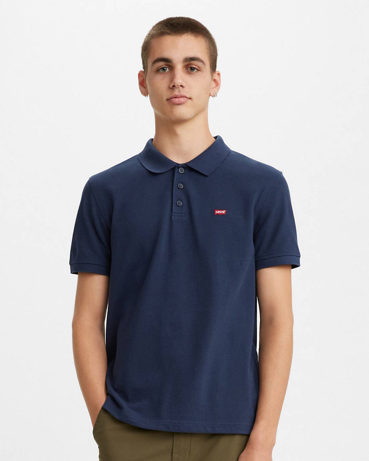Model wearing a navy blue polo shirt.