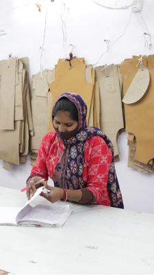 Women with fabric swatches behind her