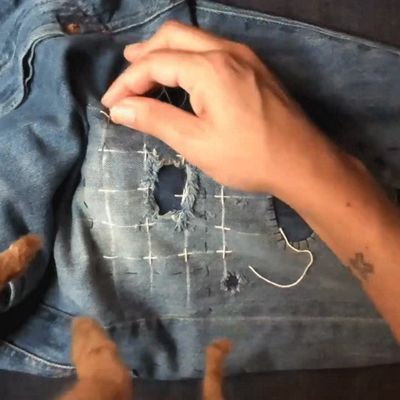 hands stitching pattern on denim jeans hands close up gif
