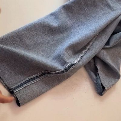 jeans inside out woman adding stitches to outseam of jeans