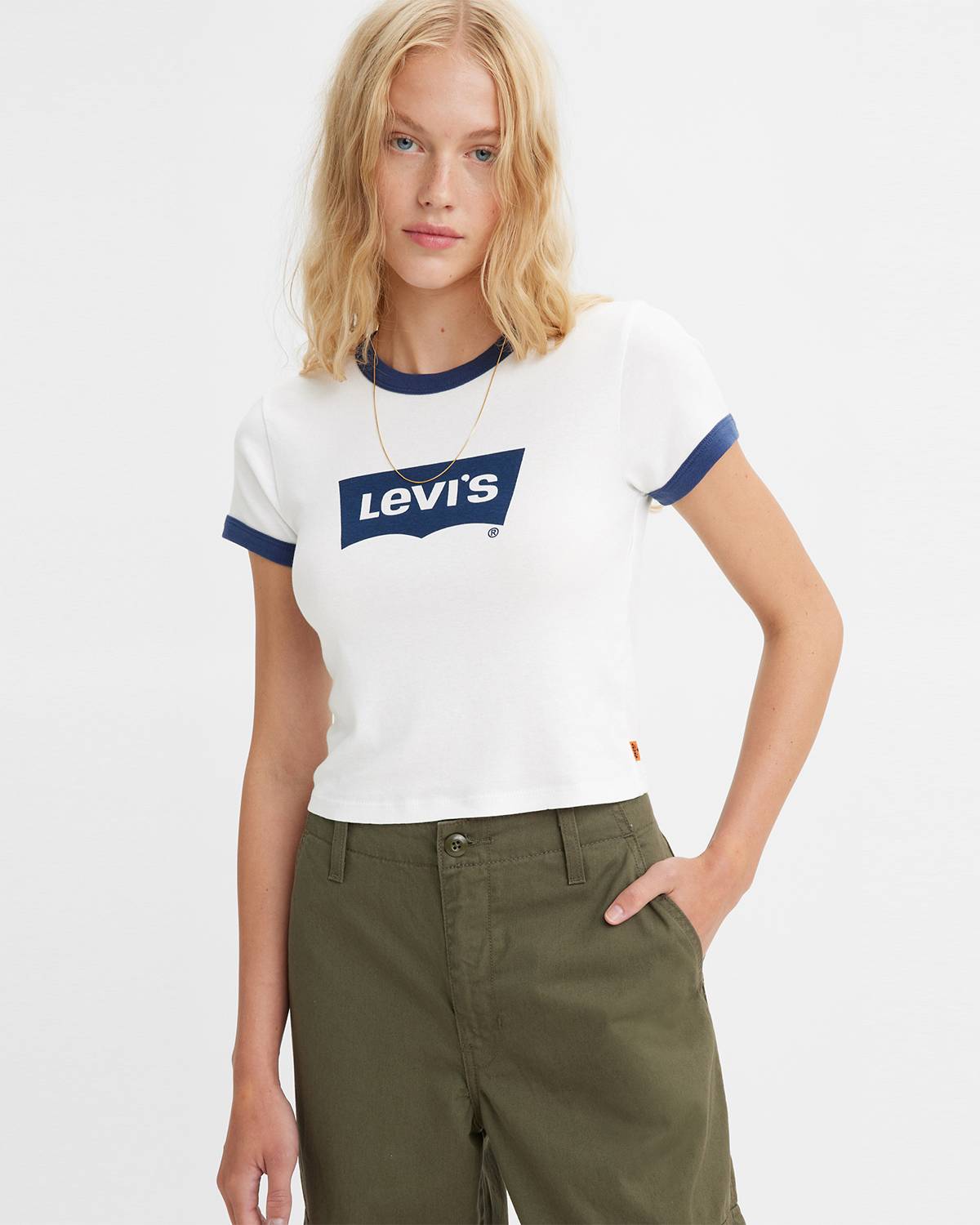 Model wearing white graphic tee with blue Levi's logo and blue embellishments.